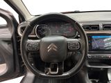 the interior of a car with a steering wheel and dashboard controls