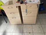 two desks with drawers and a measuring tape on top of them