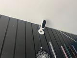 a picture of a camera and some necklaces hanging on a wall
