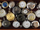 many different types of pocket watches in a box