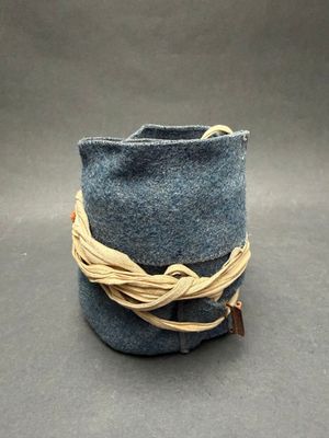 a small blue bag with a rope wrapped around it