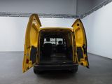 a yellow van with its doors open in a white room