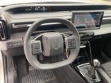 the interior of a car with a steering wheel and dashboard controls