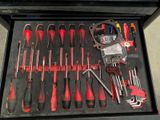 many tools in a tool box on the floor