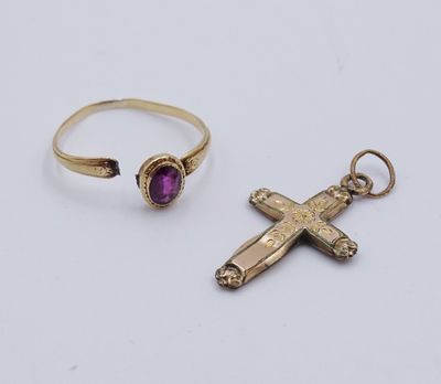 two gold rings and a cross with a purple stone