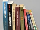 a lot of books that are stacked on top of each other