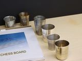 a picture of a chess board and cups on a table
