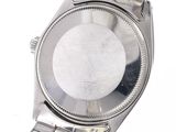 a close up of a wrist watch on a white surface