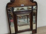 a small mirror sitting on the floor next to a fireplace