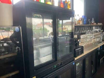 many bottles of alcohol sitting on the shelves in the bar