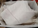 a basket full of white linens on a table