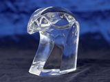 a clear glass animal figurine sitting on a black surface