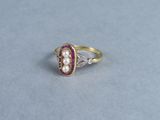 an image of a pearl and diamond ring on a table