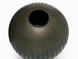 a vase that is sitting on a white surface