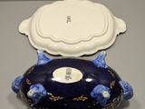 an image of a blue and white bowl with a lid on a table