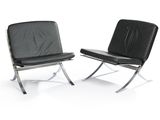 pair of black leather lounge chairs against a white background