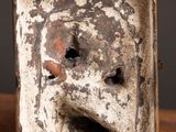 a small square shaped object with a face on it