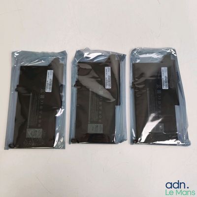 three bags of electronic equipment sitting on a table