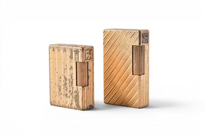 two wooden lighters sitting next to each other on a white surface