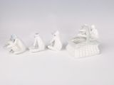 five figurines of people sitting on a bench