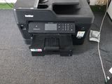 a printer that is sitting on the floor in the room