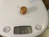 a clock on a table with a stack of coins on it