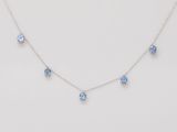 a necklace with blue crystals on a white background