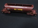 a red train car that is on a black surface