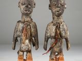 pair of carved wooden figures of a man and a woman
