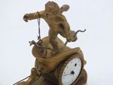 a statue of a man riding a motorcycle with a clock on it