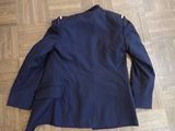 the back of a blue blazer jacket on a wooden floor