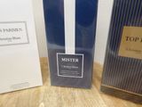 two boxes of perfume sitting on a table next to each other