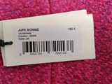 a pink sweater with a bar code on the label