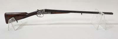 un fusil avec un canon en bois sur un support transparent