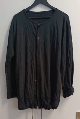 the jacket is hanging on a hanger next to a door