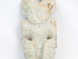 an image of a stone figurine of a man with a hat on it ' s head