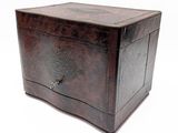 an old wooden box sitting on top of a white surface