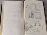 an open book with drawings on it on a table