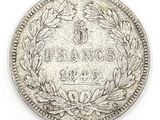 a close up of a coin on a white surface