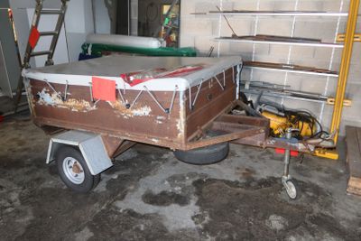 a trailer with a boat on it in a garage