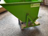 a green dumpster sitting in the middle of a room
