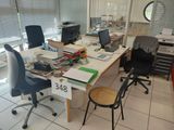a desk with a chair and a computer on it