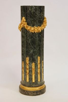 a black and gold vase with a gold decoration on it