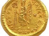 a gold coin with an image of a woman on it