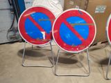 three red and blue no parking signs sitting on top of a metal stand