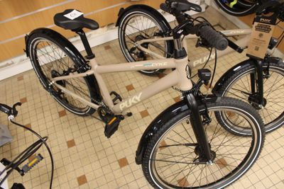two bikes that are sitting on the floor in a room