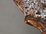a close up view of a wooden table with brown and white paint