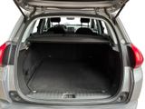 the back of a silver car with its trunk open and the back seats folded down