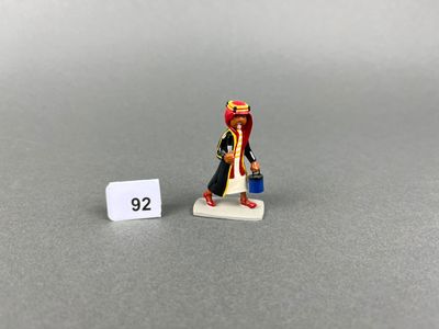 a close up of a small figurine of a man with a red hat