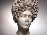 marble head of a woman with curly hair